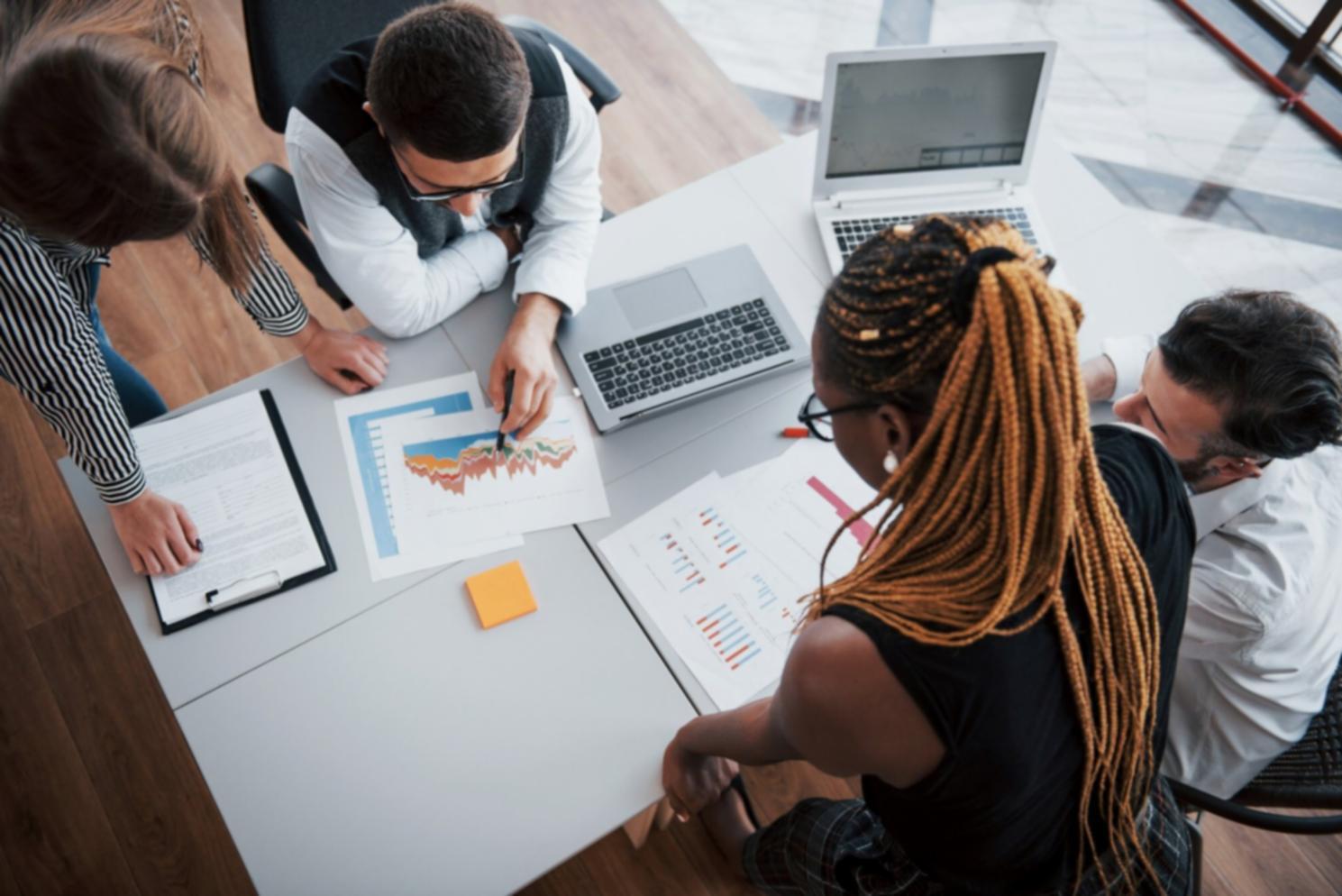 Group of people working together on financial planning exercises